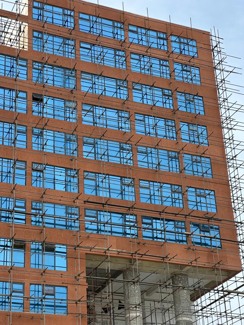 Jardex Paint site photography of facade coating work on scaffolding